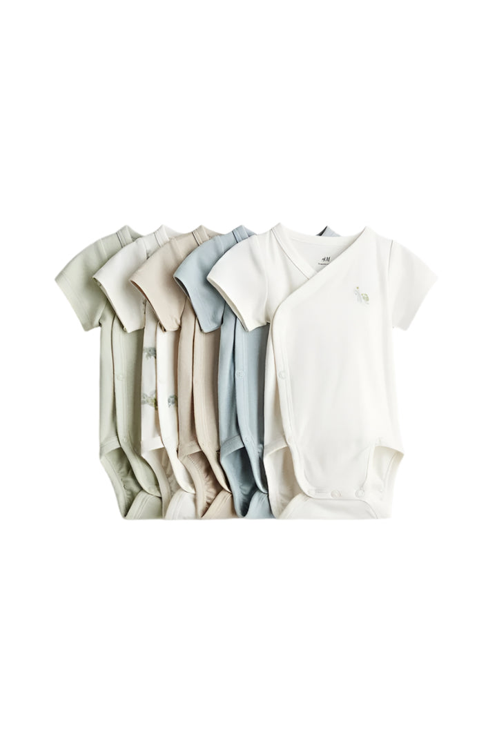 Set of baby bodysuits in various colors on a light gray background